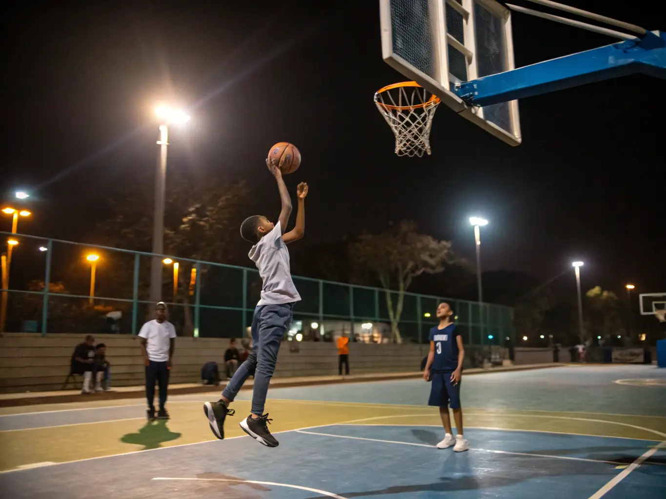 An action shot of students playing basketball in the school gymnasium, highlighting the energy and excitement of the game.